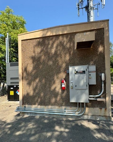 Wide view of generator shelter installation at a commercial site