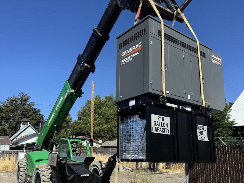 Generator being placed on site with a telehandler lift